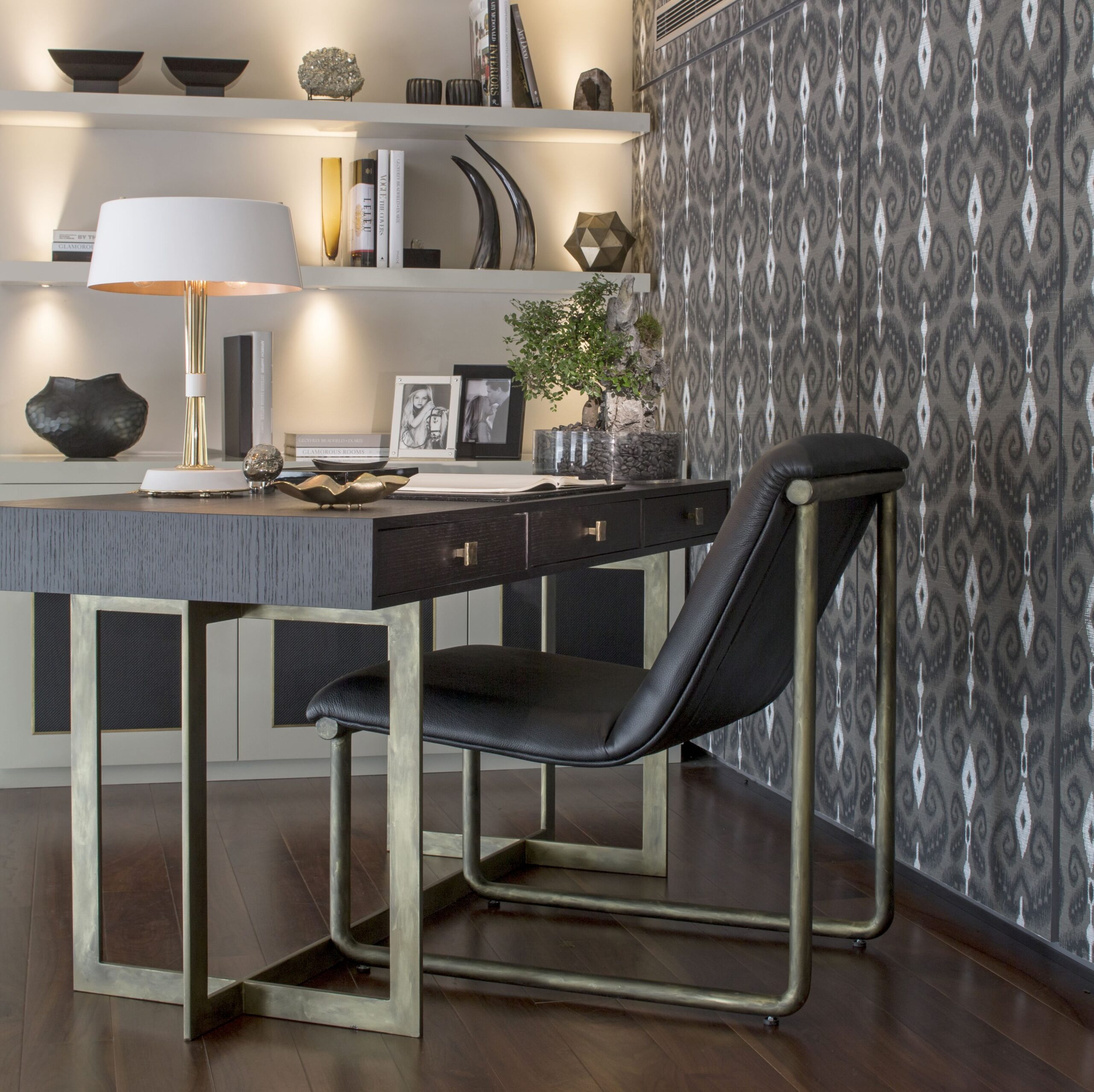 dark-wood-desk-black-chair-shelves-decor-table-lamp-pattern-wallpaper-home-office 02