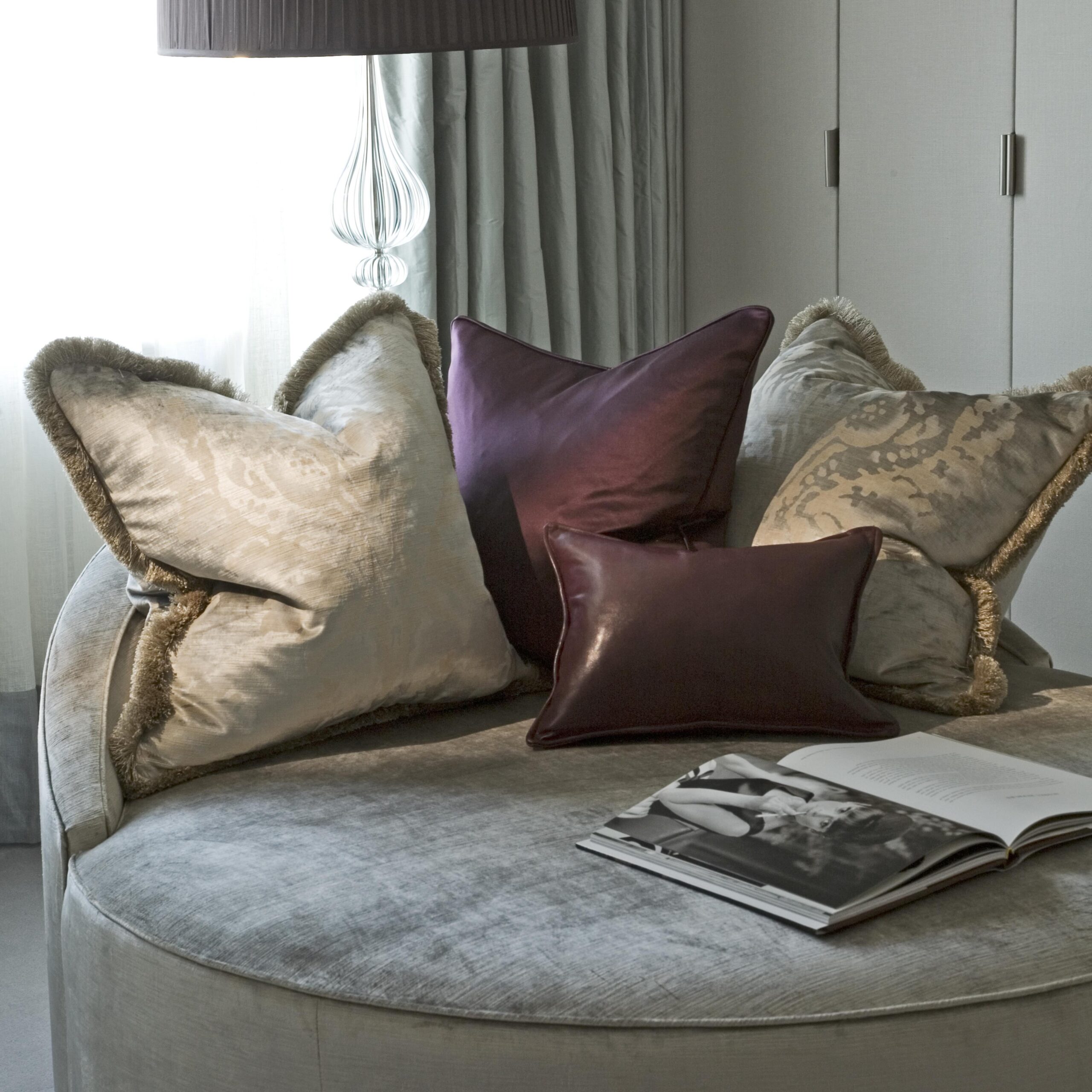 upholstered-bench-cushions-throw-pillows-book-on-seat-window-light-10
